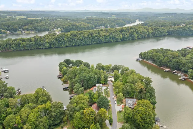 an aerial view of a houses with a lake view