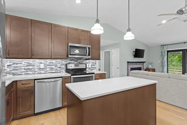 a kitchen with a stove a sink and a refrigerator