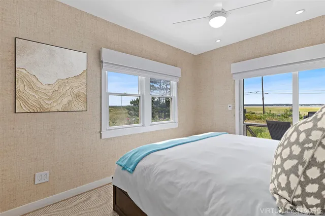 a bed sitting in a bedroom next to a window