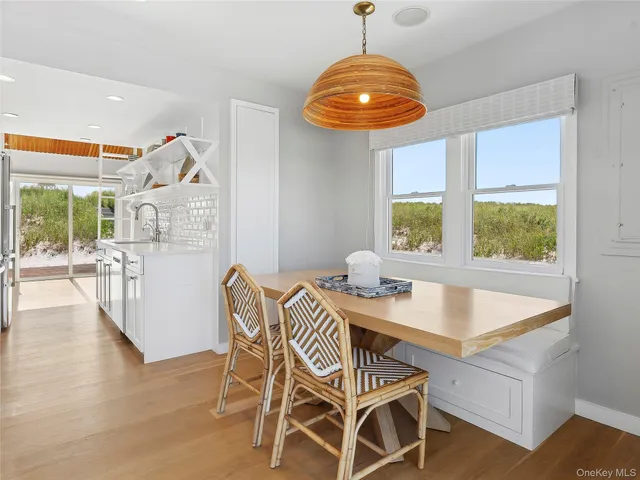 a view of a dining room with furniture wooden floor and chandelier