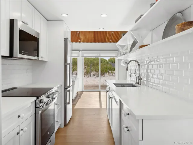 a kitchen with a sink and a stove top oven
