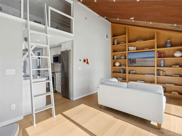 a living room with furniture and kitchen view