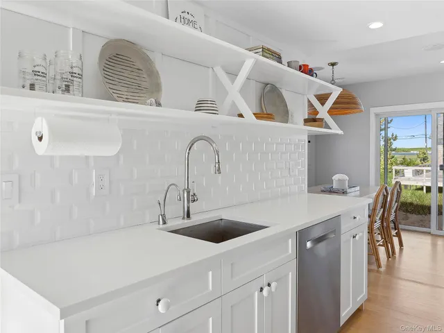 a kitchen with a sink dishwasher and cabinets