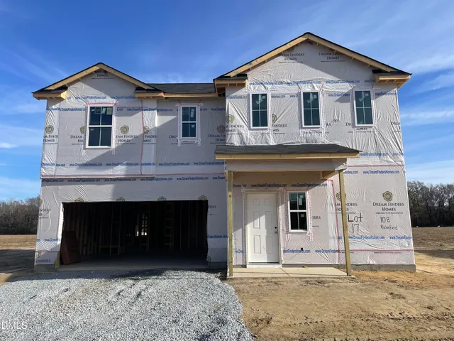 a front view of a house with garage