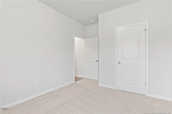 a view of a small space with wooden floor and a window