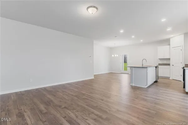 a view of kitchen with wooden floor and electronic appliances