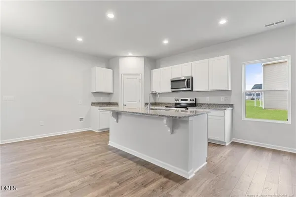 a kitchen with stainless steel appliances granite countertop a sink and cabinets