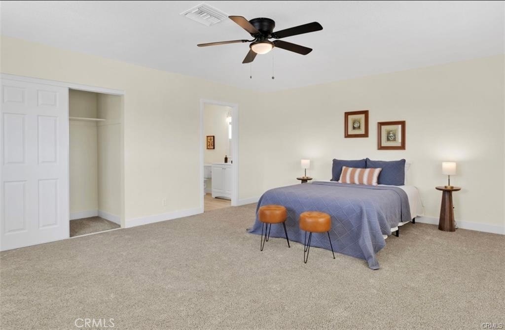 351 Armory Road Barstow, CA 92311 - Photo 11 of 31 a bedroom with a bed and a chandelier