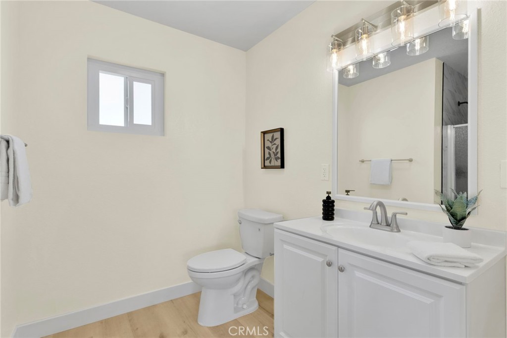351 Armory Road Barstow, CA 92311 - Photo 14 of 35 a bathroom with a toilet sink and mirror