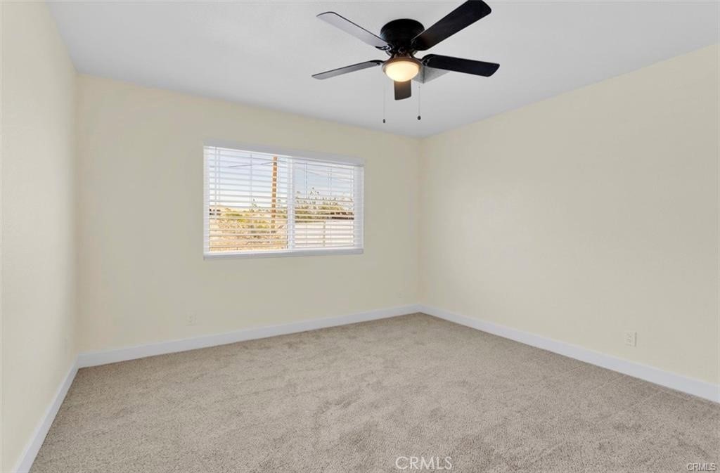 351 Armory Road Barstow, CA 92311 - Photo 15 of 31 an empty room with a window and a fan