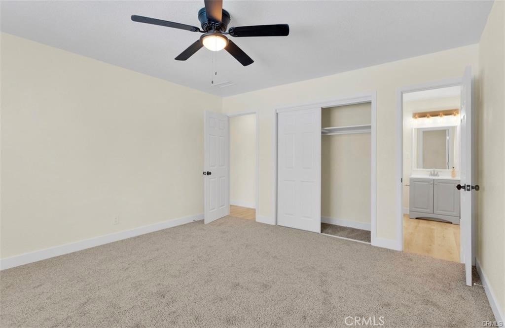 351 Armory Road Barstow, CA 92311 - Photo 18 of 35 an empty room with closet and a ceiling fan
