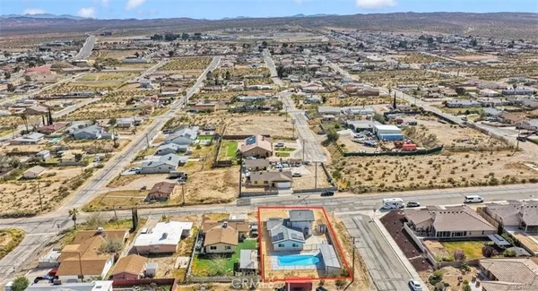 an aerial view of a house with a yard
