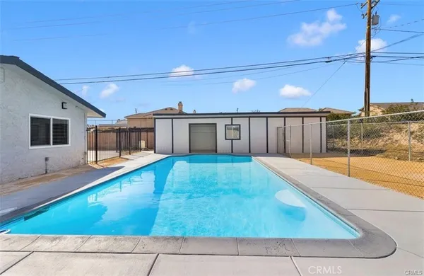 a view of a house with swimming pool in front of it