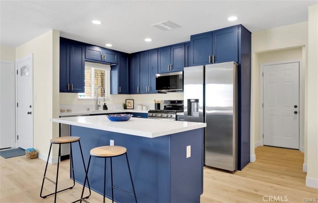 351 Armory Road Barstow, CA 92311 - Photo 8 of 31 a kitchen with stainless steel appliances a refrigerator and a stove top oven
