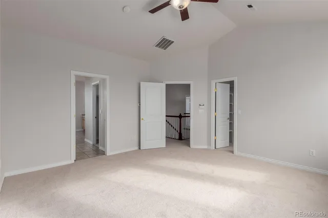 a view of empty room with ceiling fan