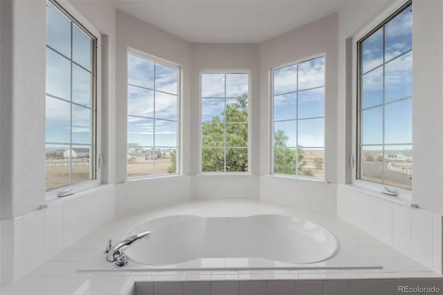 a white bath tub sitting next to a window