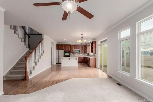 a view of a livingroom with a ceiling fan and window