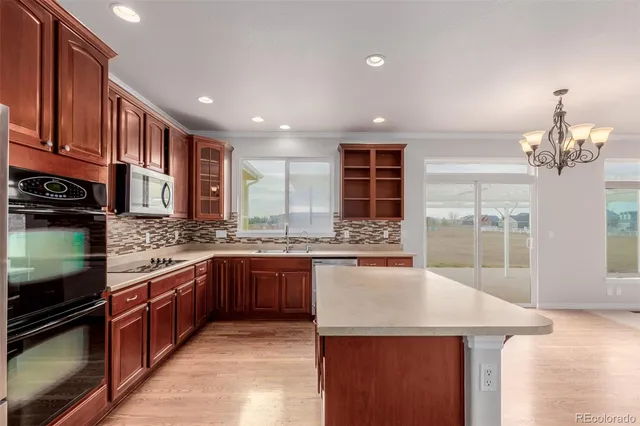 a kitchen with stainless steel appliances granite countertop stove top oven and sink