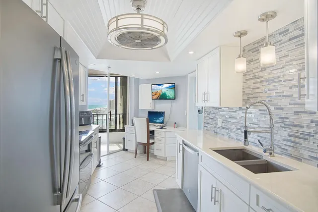 a kitchen with a sink stove and cabinets