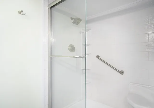 a bedroom with two beds and a large window