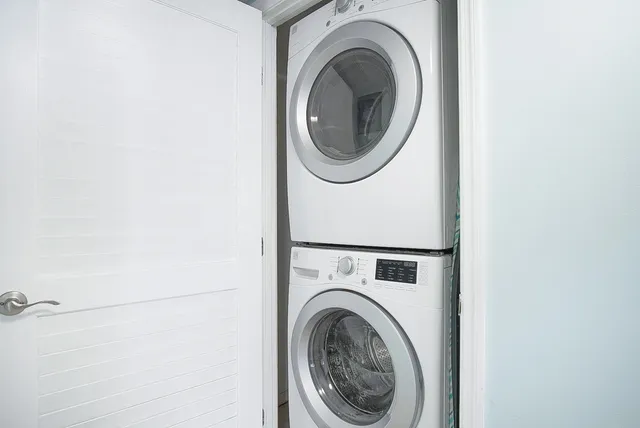 a view of a swimming pool with lawn chairs under an umbrella