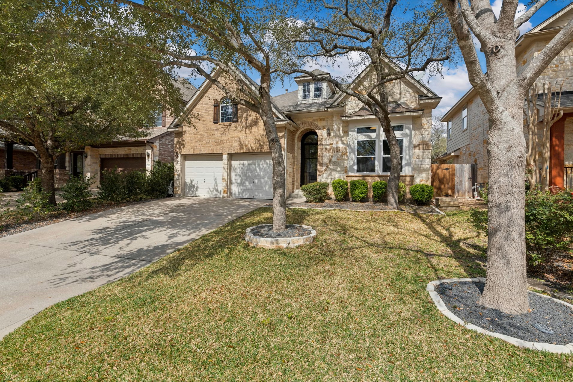 320 El Socorro Lane Austin, TX 78732 - Photo 36 of 40 a front view of a house with garden