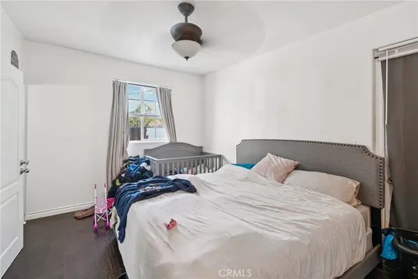 a bedroom with a bed and a chandelier