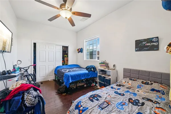 a bedroom with bed and a chandelier