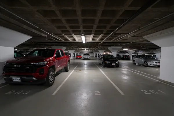 a view of parking garage with cars parked