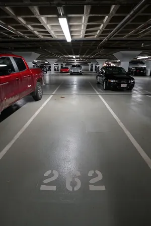 a view of parking garage with cars