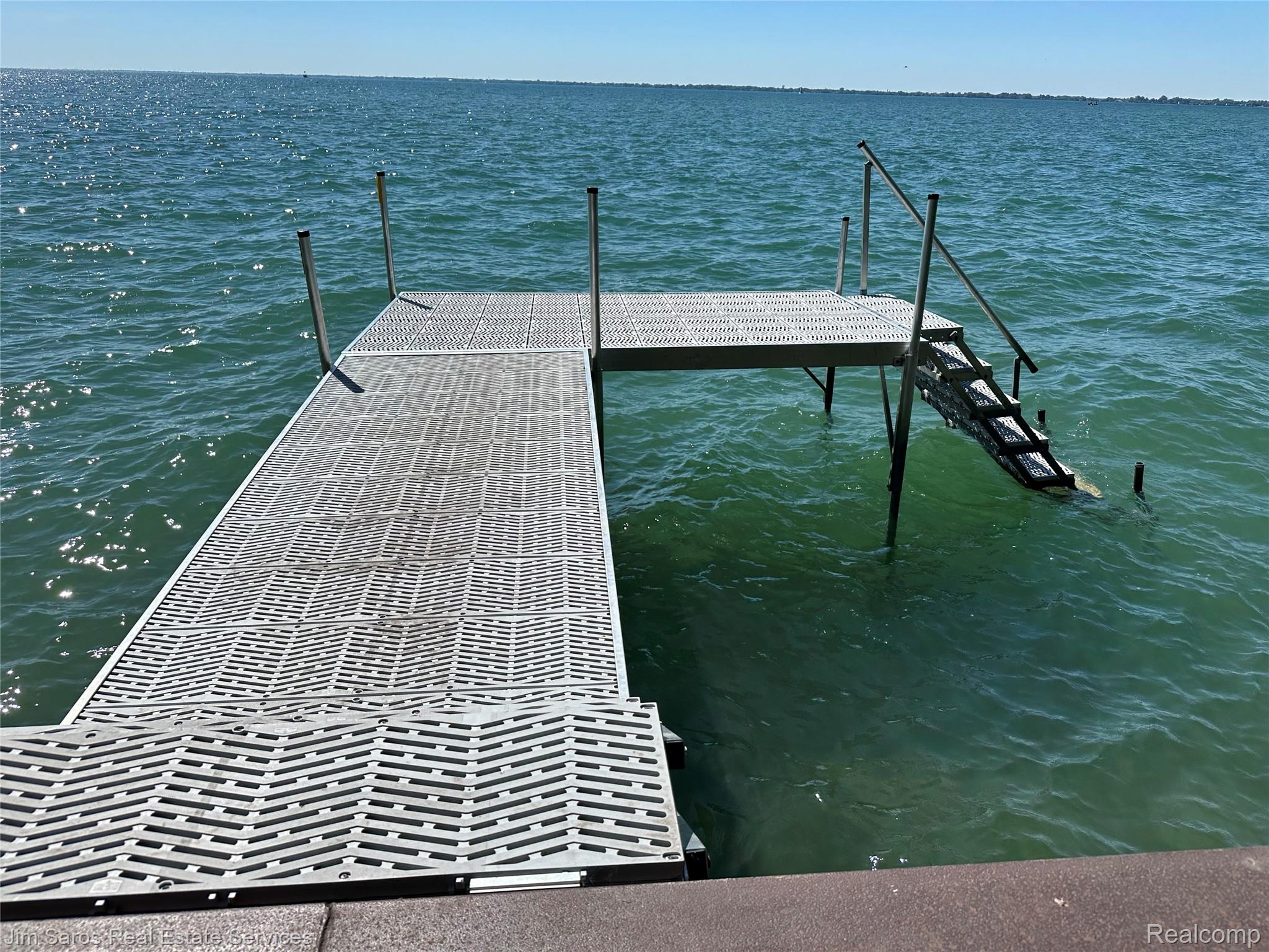 910 Edgemont Park Grosse Pointe, MI 48230 - Photo 54 of 56 Waterfront access featuring a metal dock with integrated steps and handrails, providing direct entry to the water