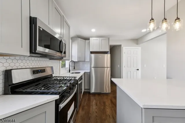 a kitchen with a stove and a microwave