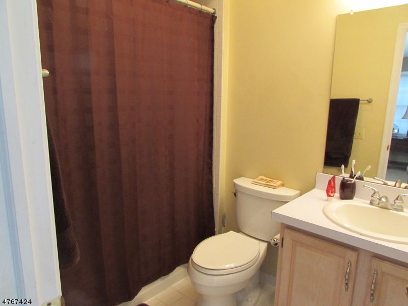 8 Genoble Road Montville, NJ 07045 - Photo 9 of 12 a bathroom with a sink toilet and mirror
