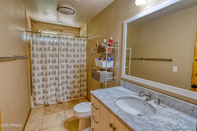 a open kitchen with stainless steel appliances granite countertop a table chairs and a refrigerator