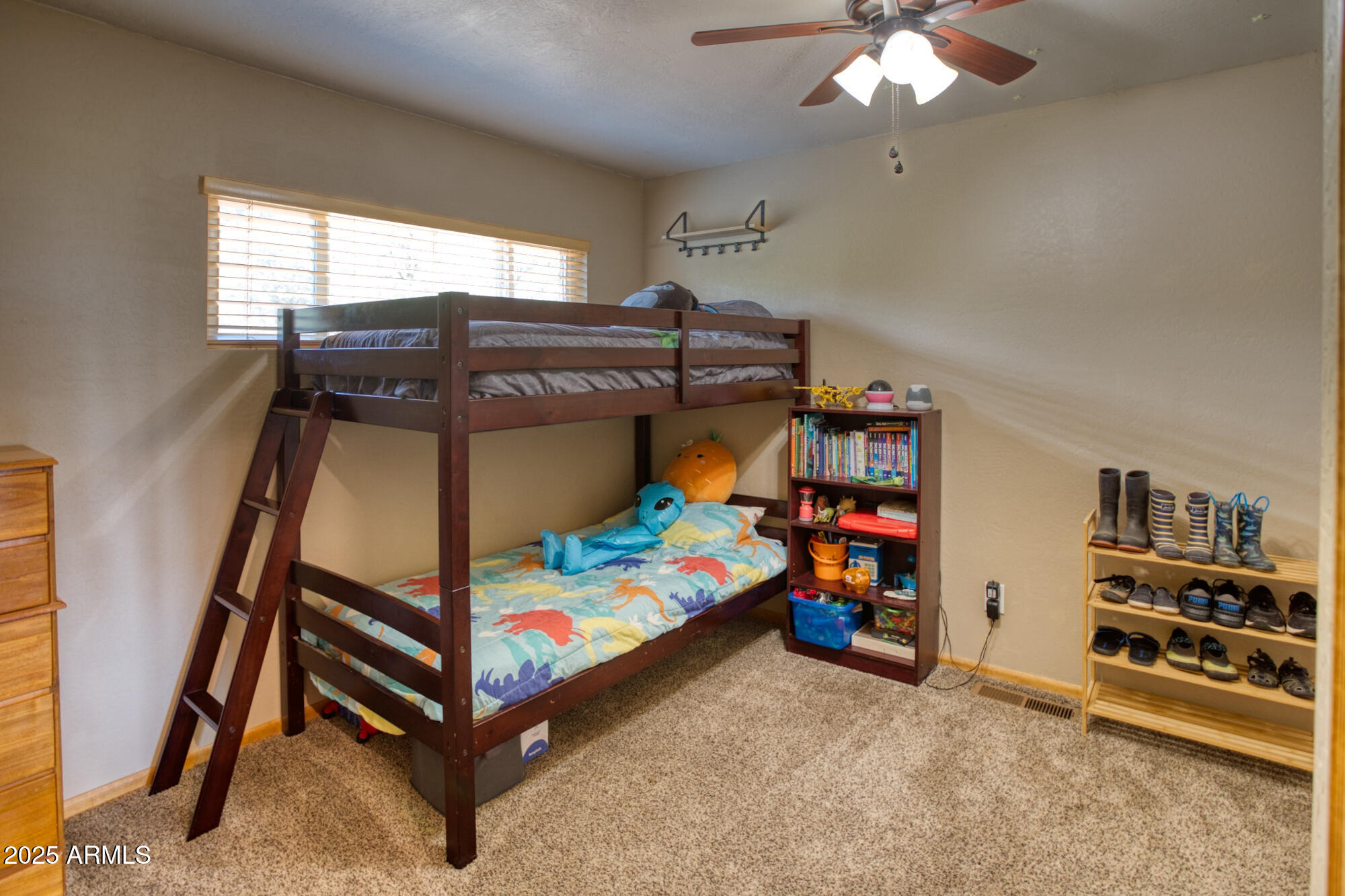 2611 Ellsworth Avenue Show Low, AZ 85901 - Photo 15 of 41 a bedroom with bunk beds and a chandelier