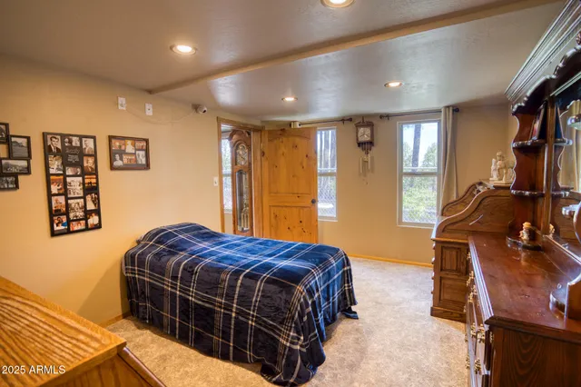 a view of a livingroom with furniture and a flat screen tv