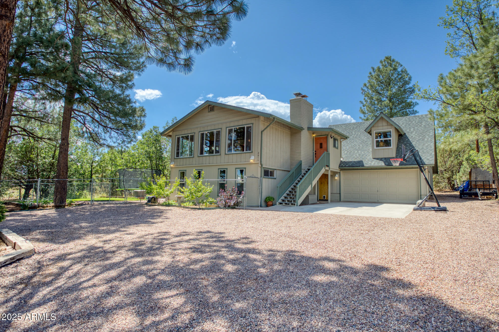 2611 Ellsworth Avenue Show Low, AZ 85901 - Photo 2 of 41 a front view of a house with a yard and garage