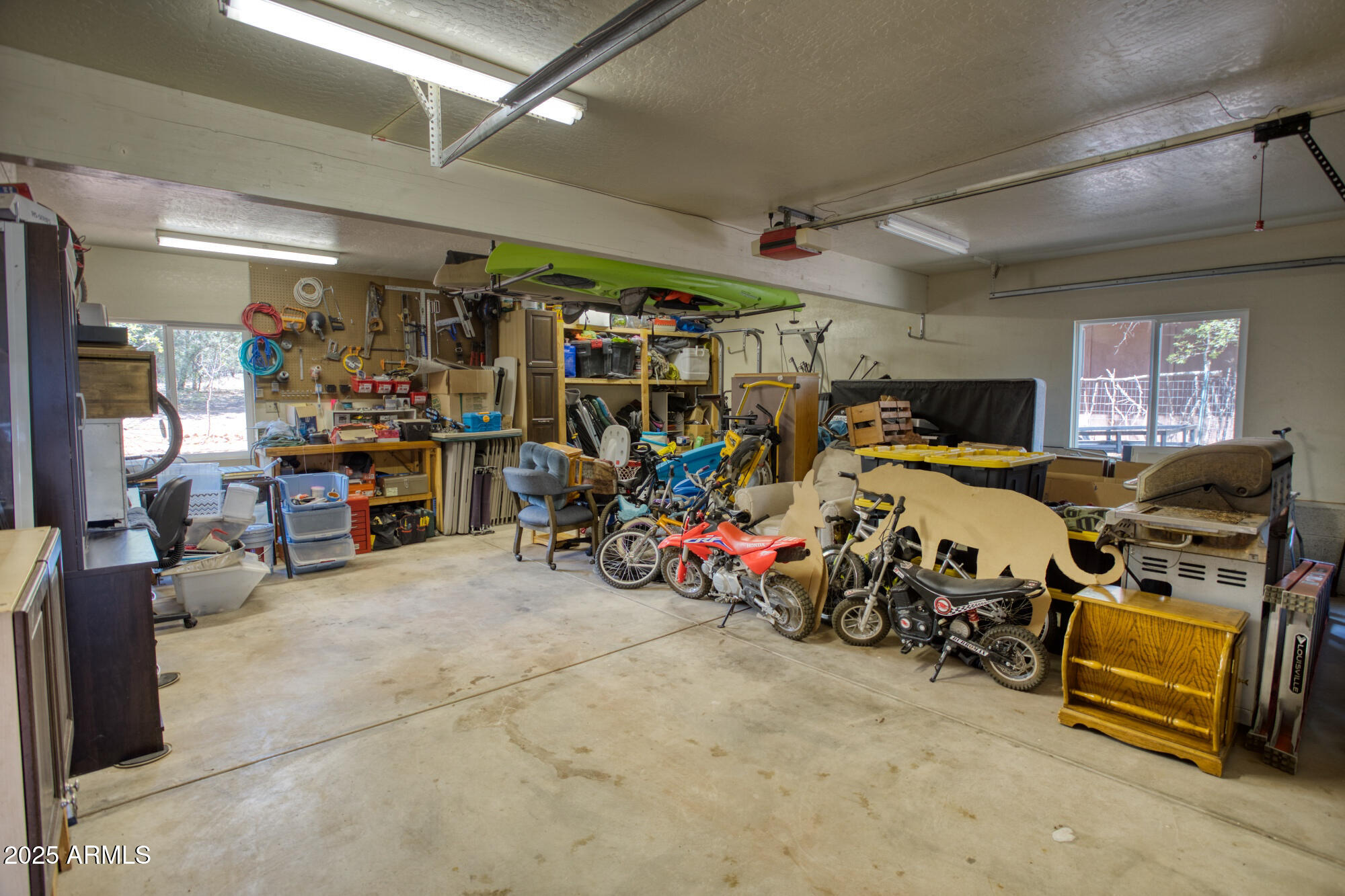 2611 Ellsworth Avenue Show Low, AZ 85901 - Photo 31 of 41 a view of a garage with a bike and car