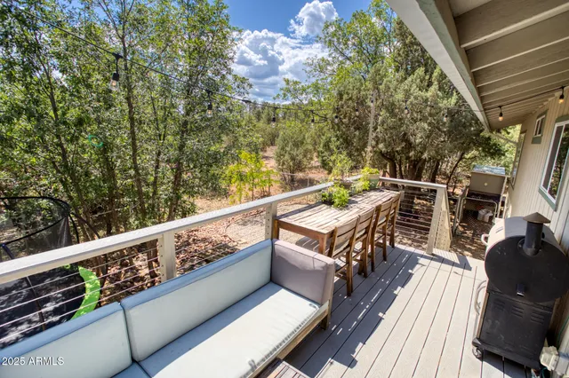 a view of balcony with wooden floor and seating space