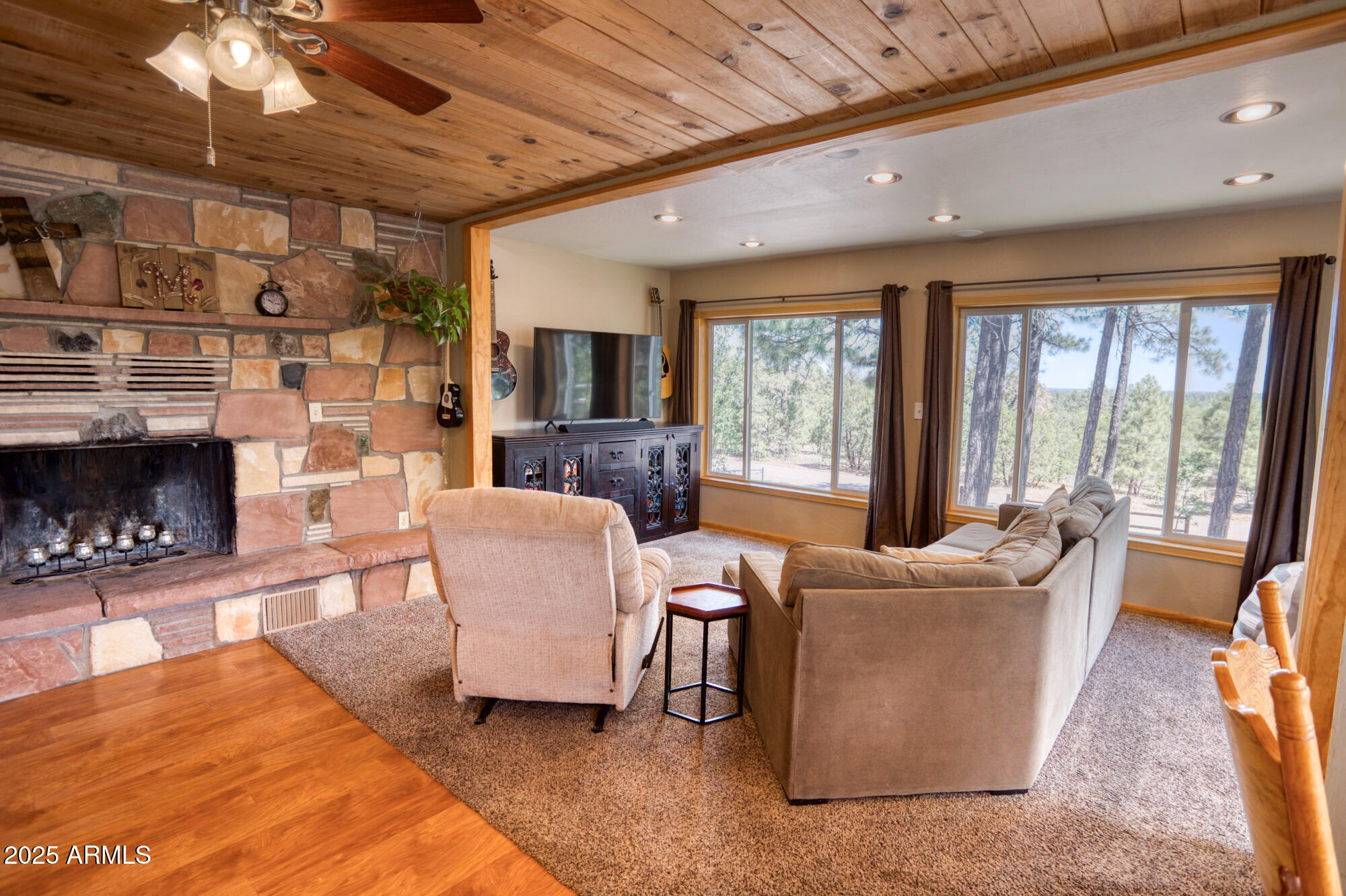 2611 Ellsworth Avenue Show Low, AZ 85901 - Photo 6 of 41 a living room with couches a flat screen tv and a fireplace