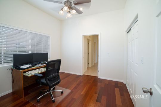 411 North Nolan Street Ridgecrest, CA 93555 - Photo 23 of 43 a view of a workspace with furniture and wooden floor