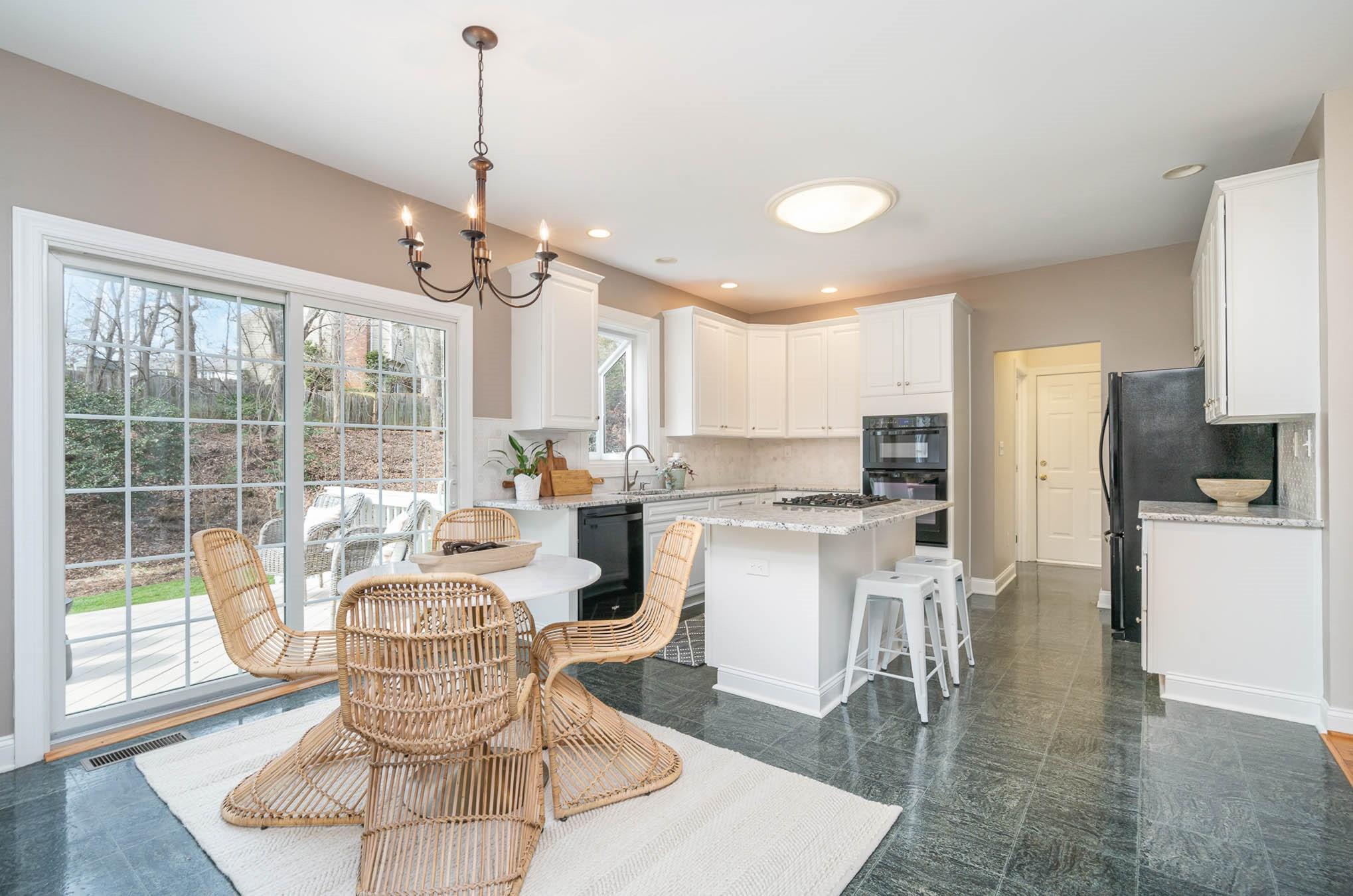 3924 Highview Road Charlotte, NC 28210 - Photo 11 of 45 a living room with stainless steel appliances granite countertop furniture a rug a chandelier and a view of kitchen