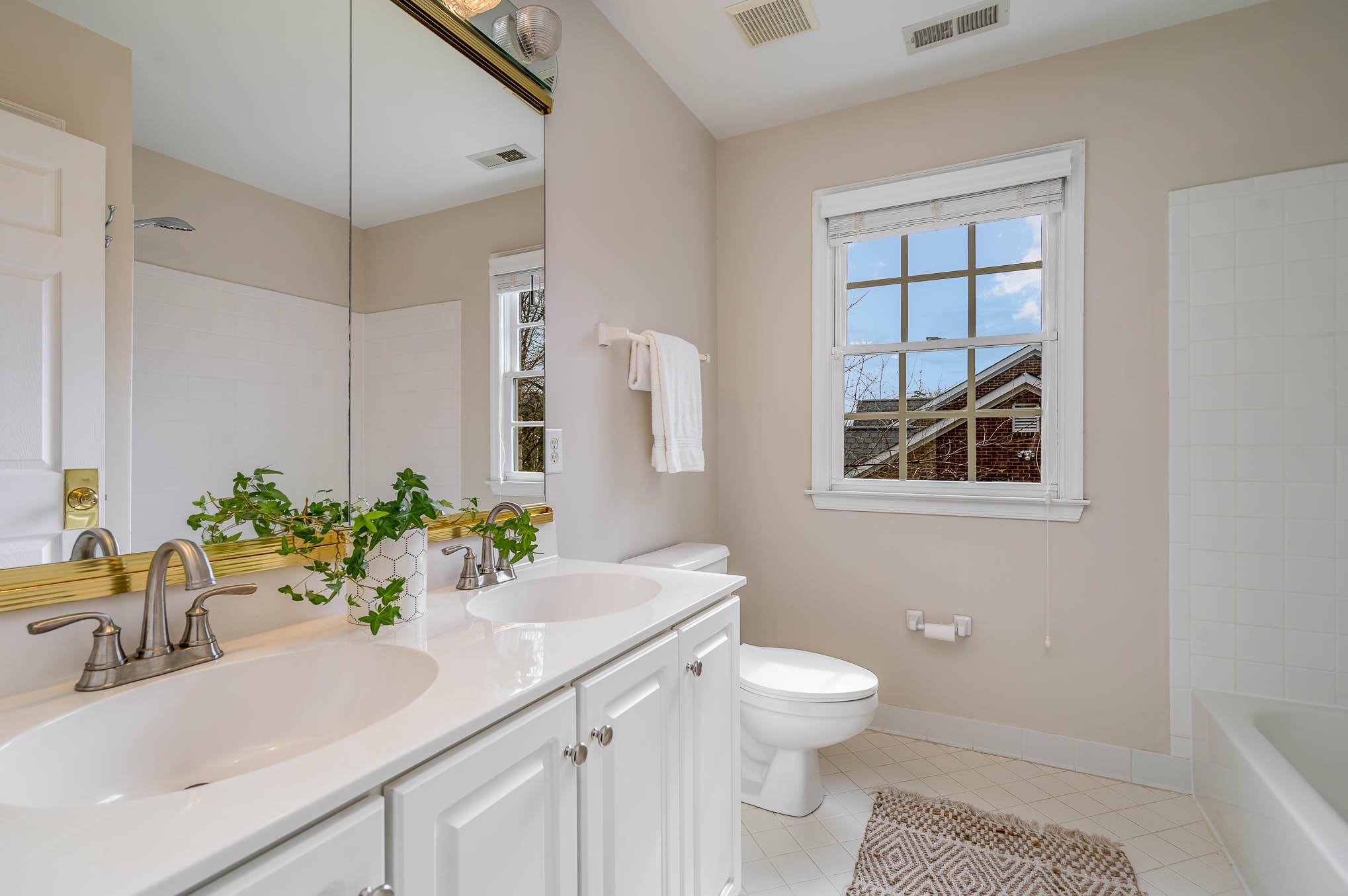 3924 Highview Road Charlotte, NC 28210 - Photo 28 of 45 a bathroom with a sink toilet a mirror and shower