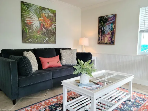 a living room with furniture potted plant and a lamp