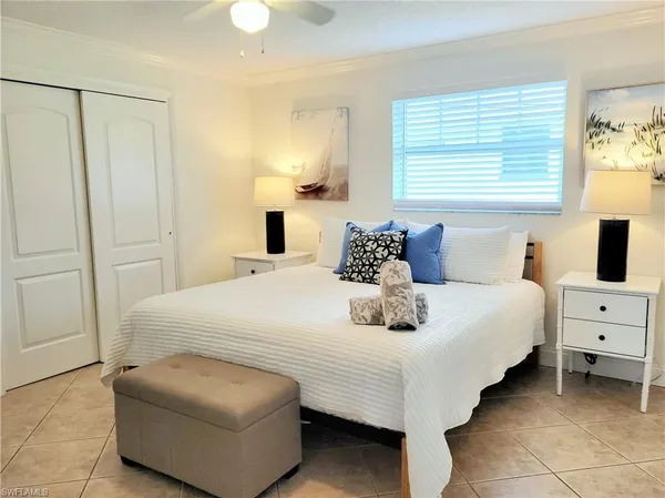 a bedroom with a bed and a night stand