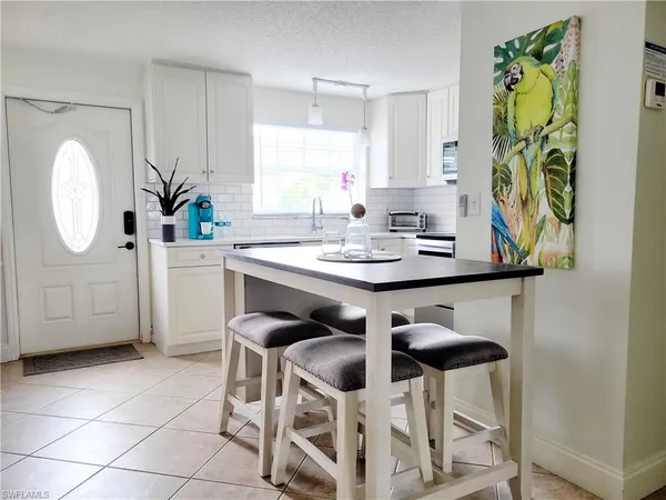 a view of a dining room cabinets a table and chairs