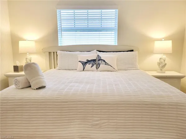 a large white bed in a white room