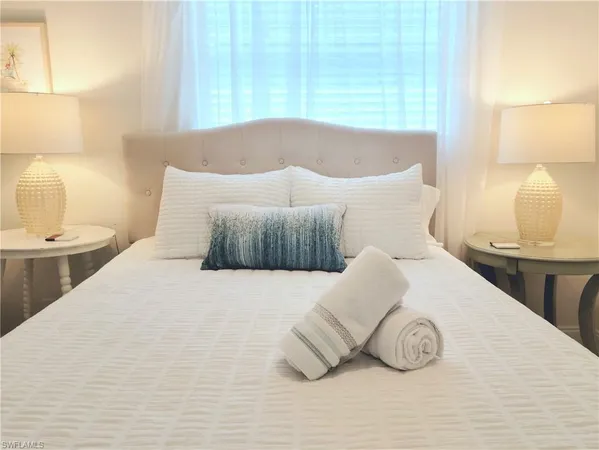 a bedroom with a bed and a lamp