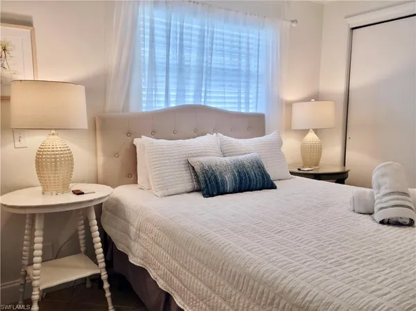 a bedroom with a bed and a table