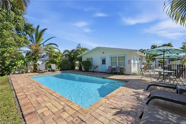 a view of a house with backyard and sitting area
